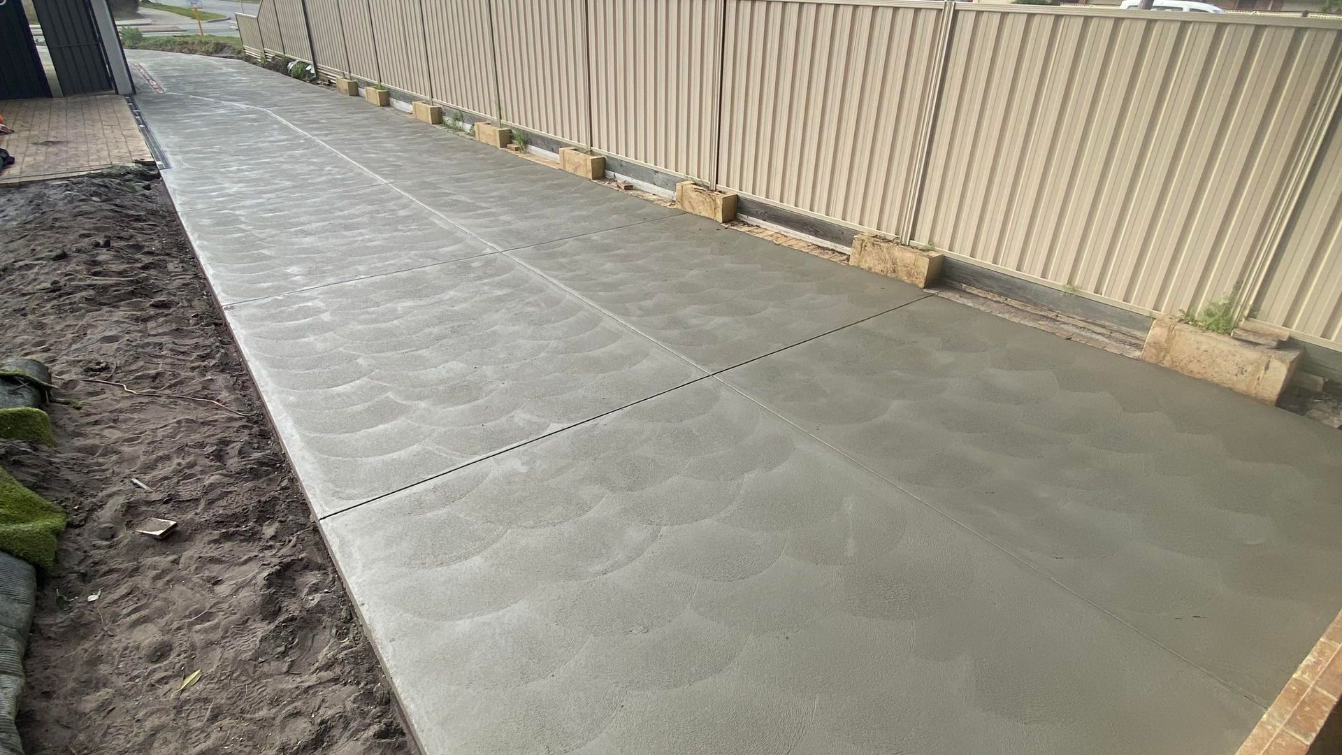 Sponge finished grey concrete driveway 