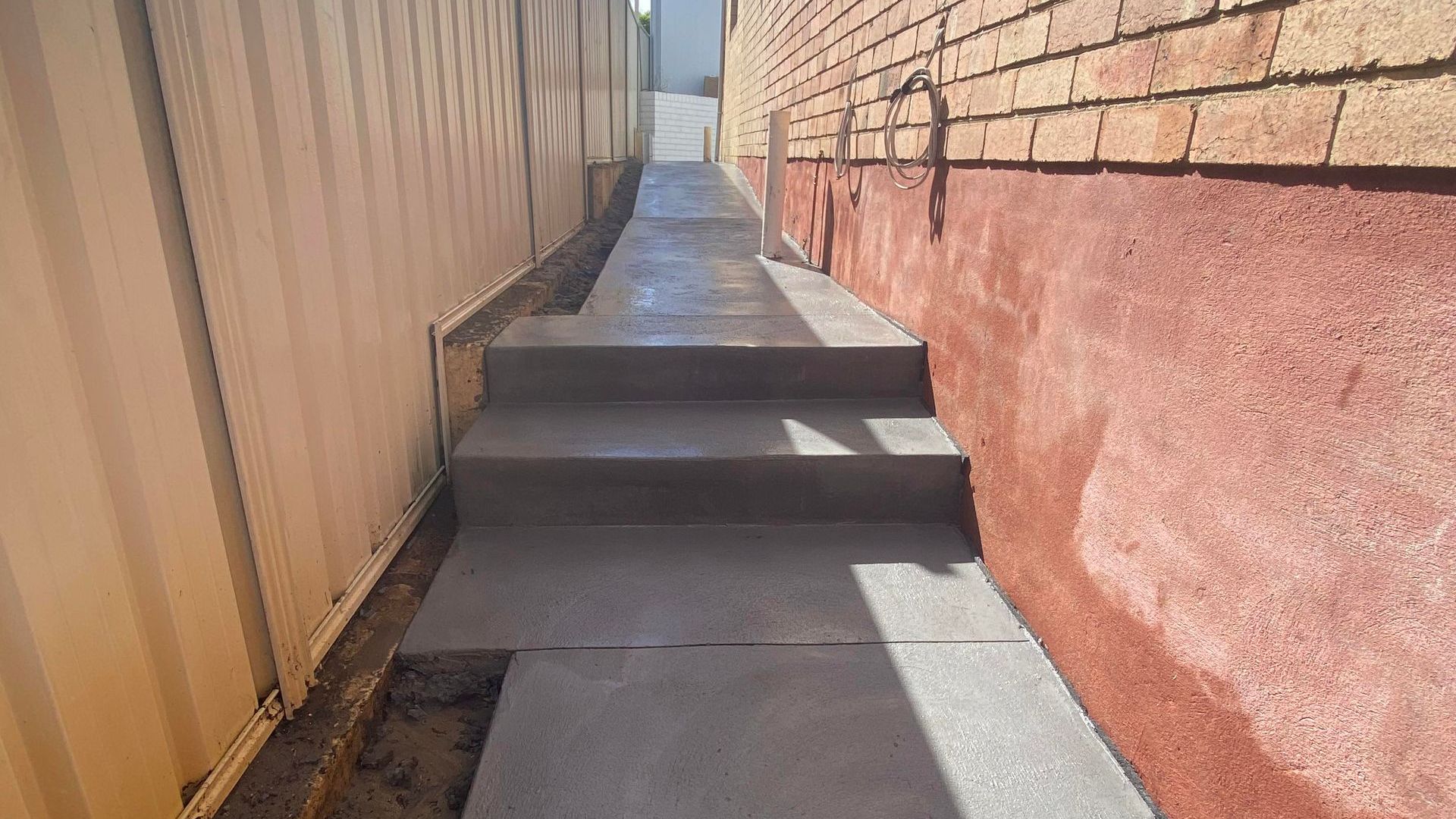 Grey Concrete Steps Down the Side of a Home Grey Concrete Steps Down the Side of a Home