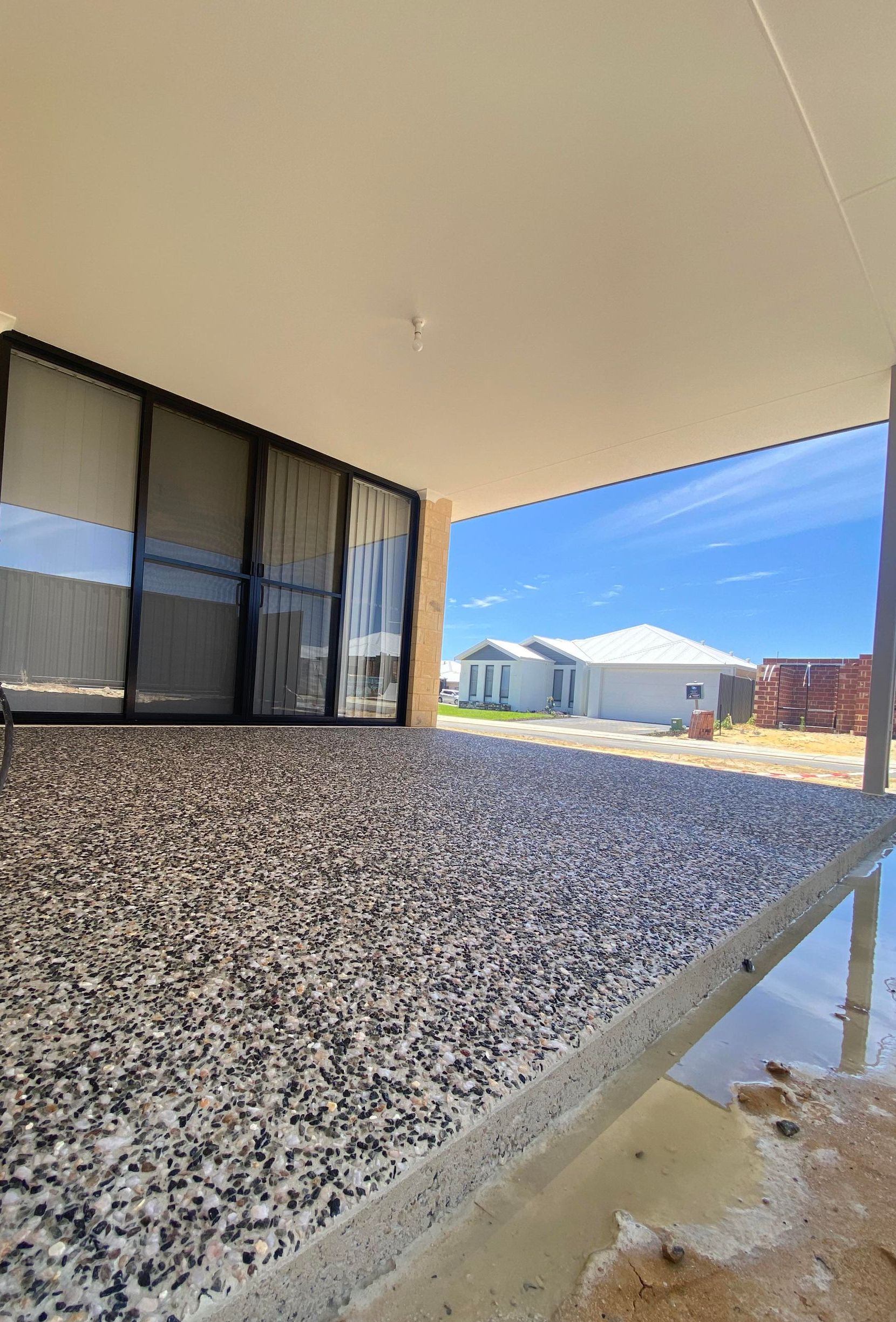 grey exposed aggregate patio/alfresco solution