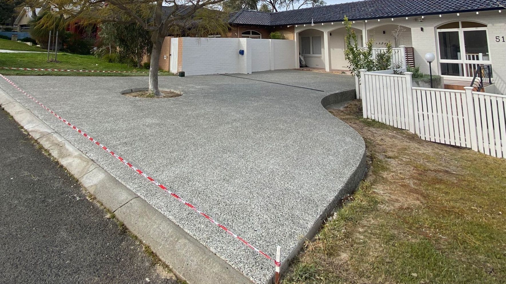 stunning exposed aggregate driveway with curvy driveway outline