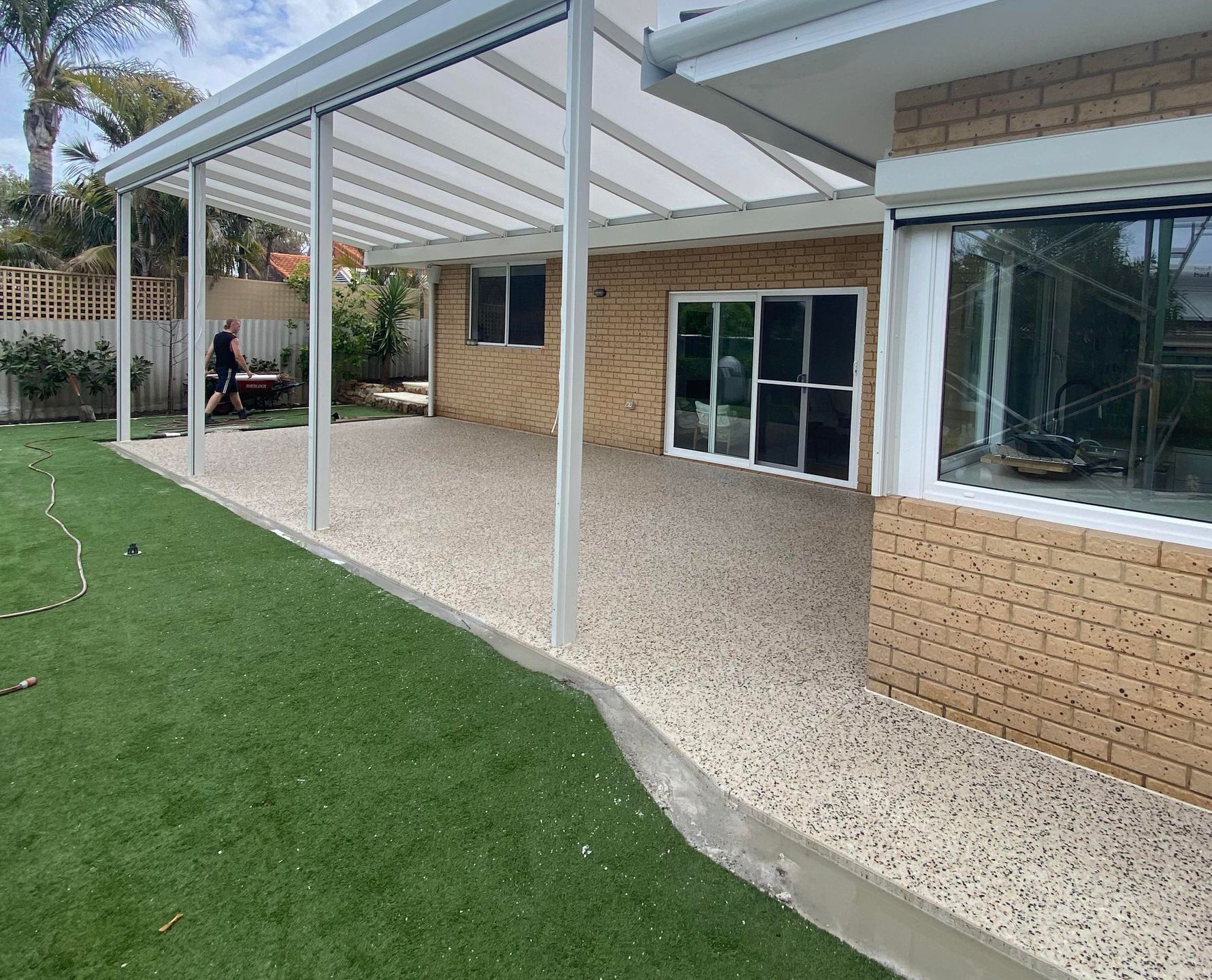 Honed concrete patio with pergola over the top