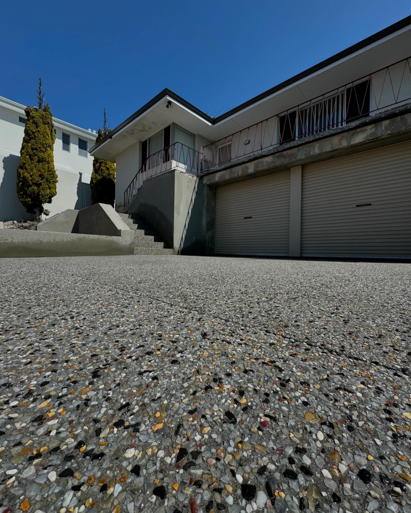 Exposed aggregate concrete application complimented by concrete stairs.