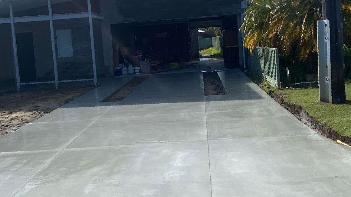 Grey Concrete Driveway for New Home Landscaping