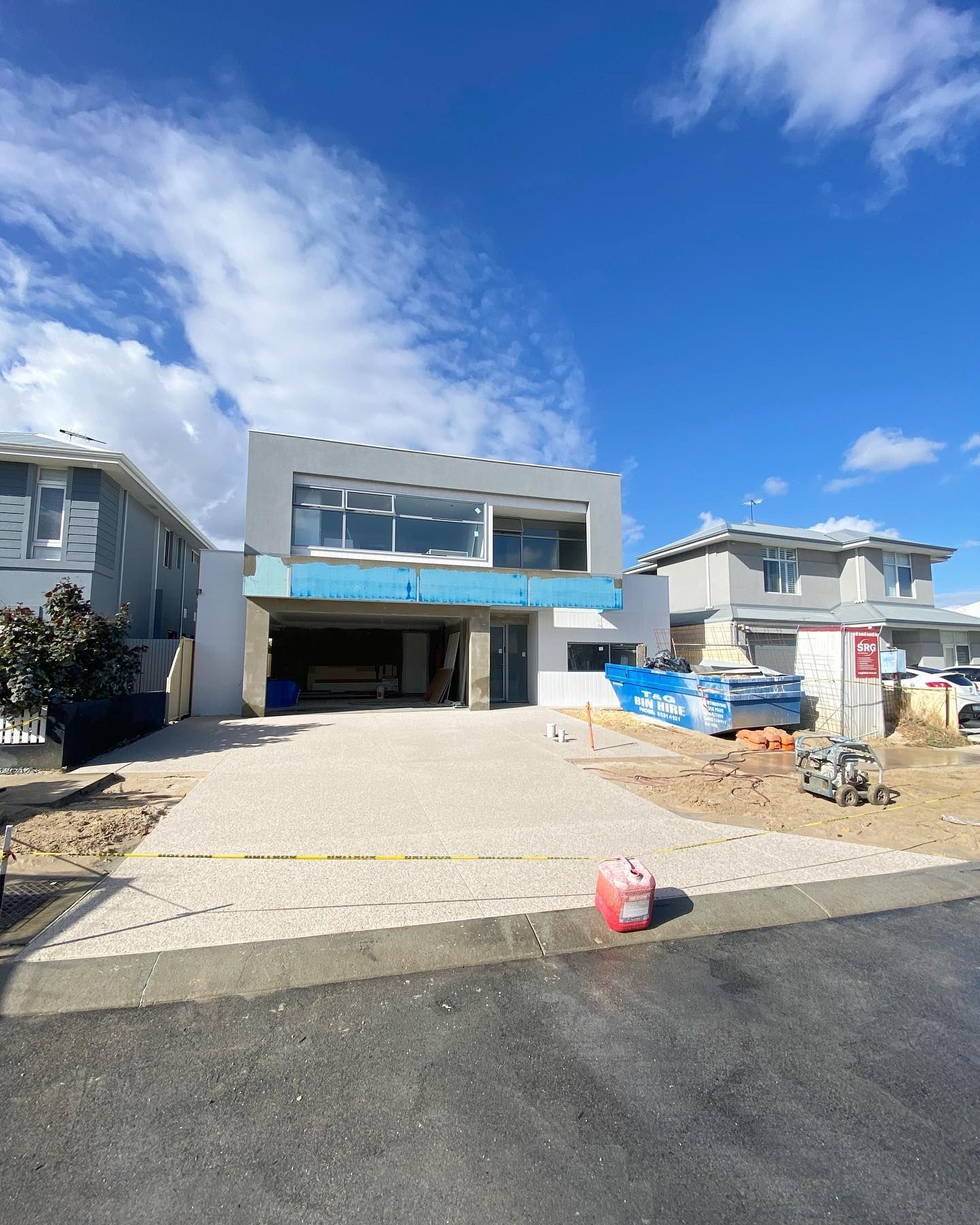 new two storey home being built with new concrete driveway in an exposed aggregate finish.