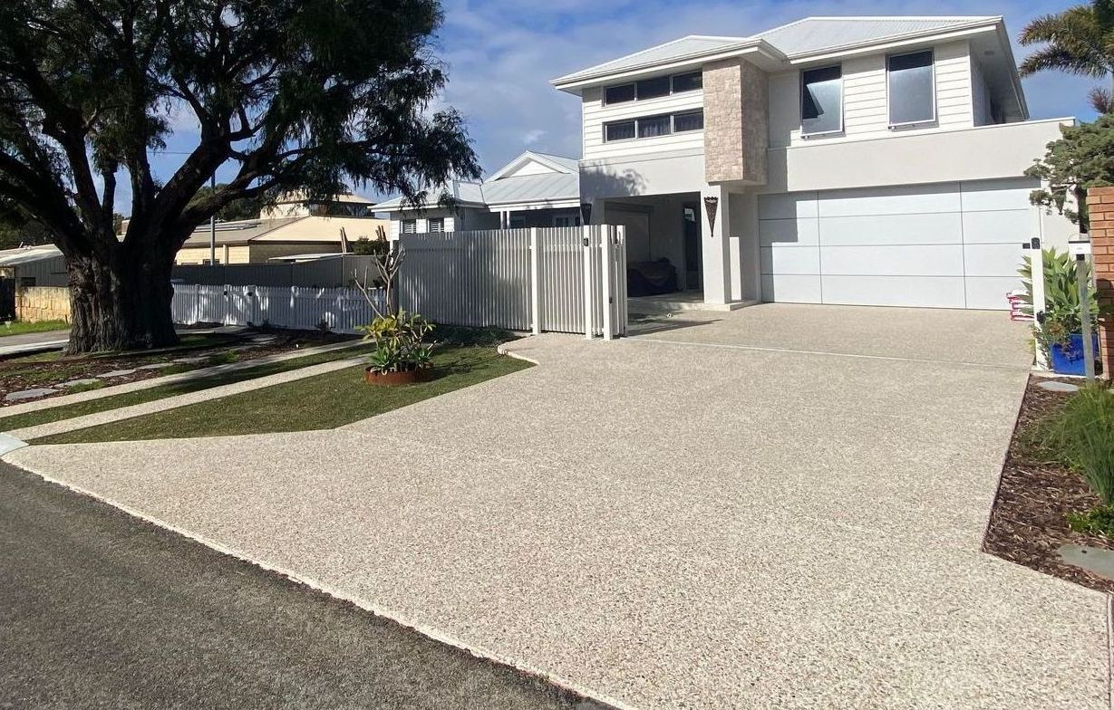 Exposed aggregate driveway in front of two storey house