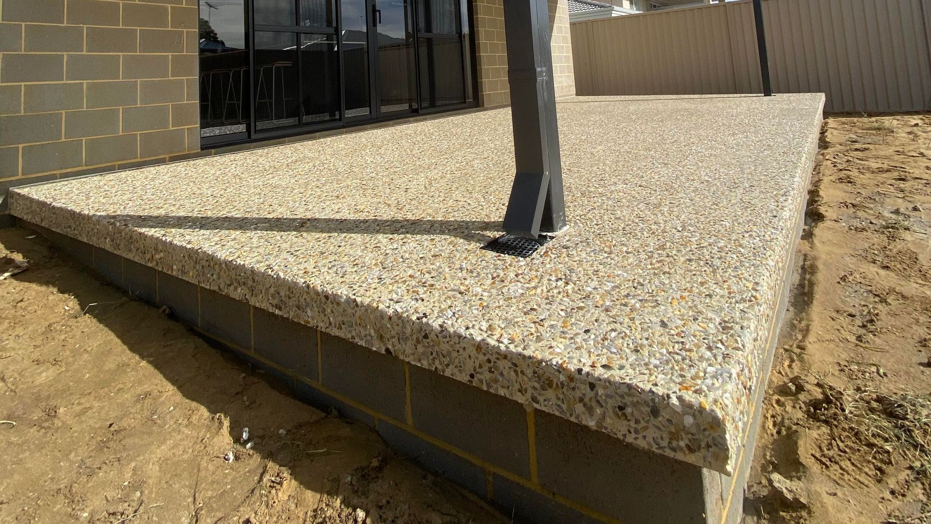 Decorative concrete alfresco floor with over hang feature