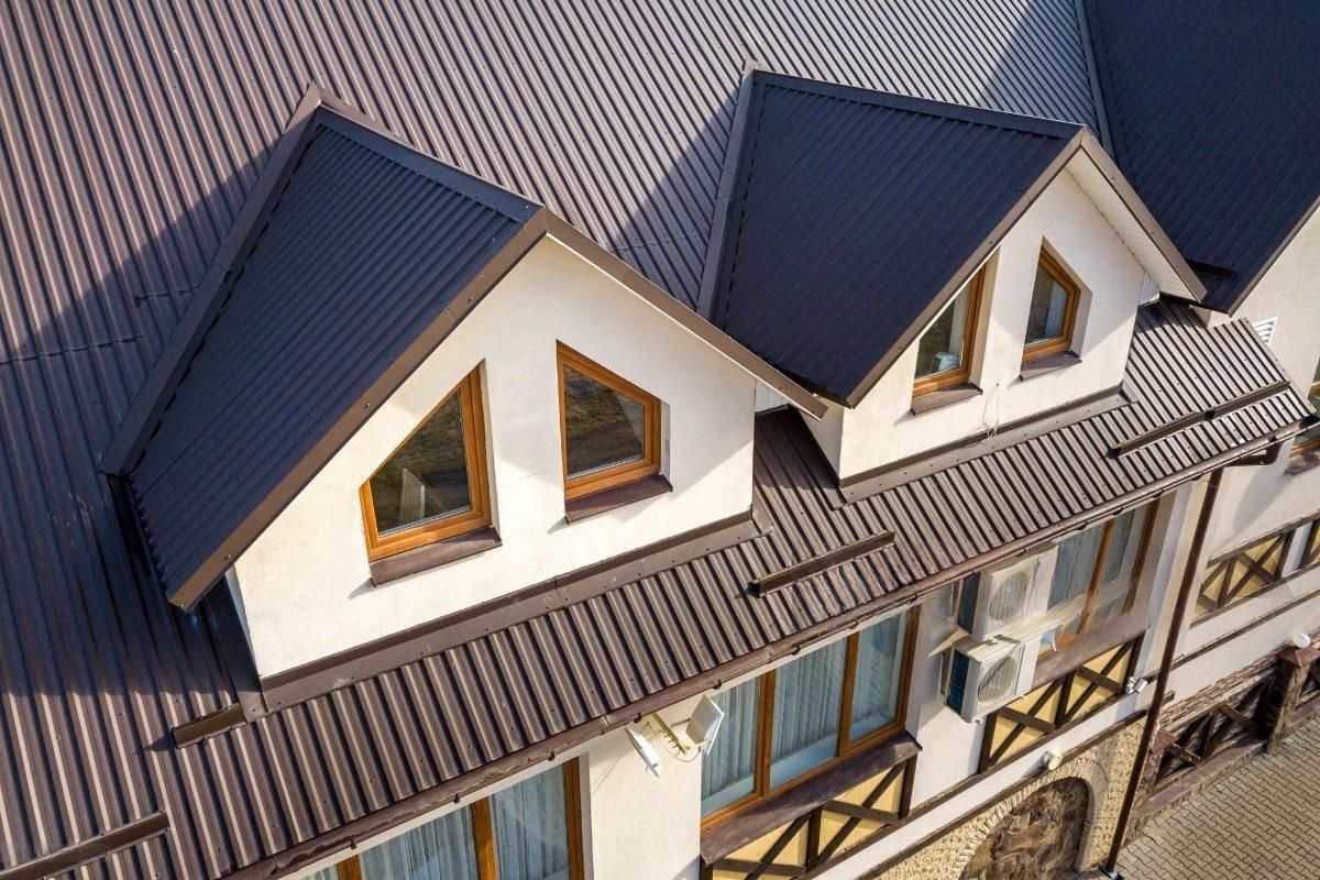 a house with a brown roof and three windows