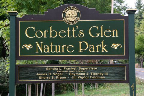 a green sign for corbett 's glen nature park