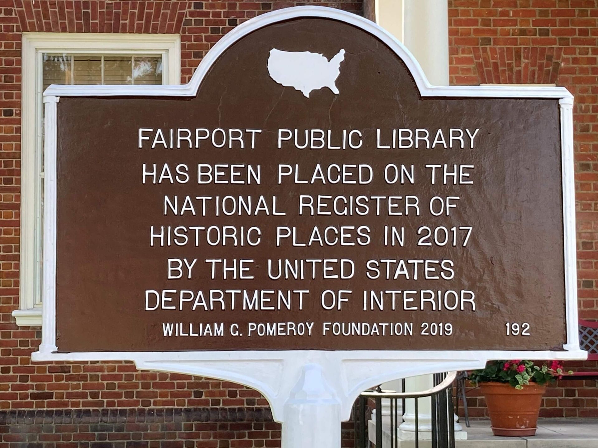 a sign that says fairport public library has been placed on the national register of historic places in 2017 by the united states department of interior