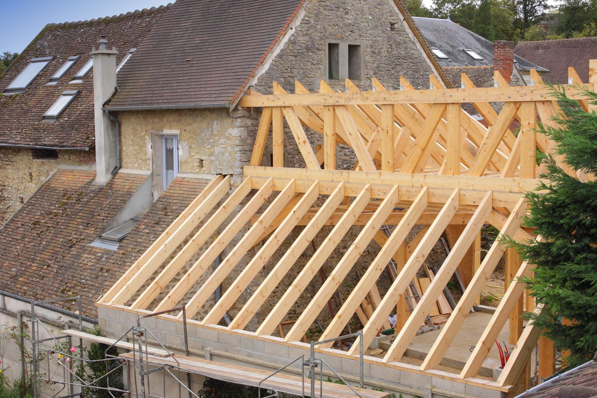 a wooden structure is being built on top of a house