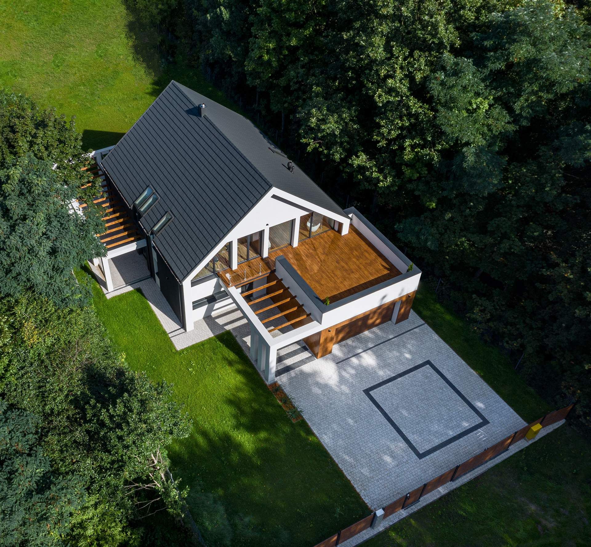 an aerial view of a house with a black roof