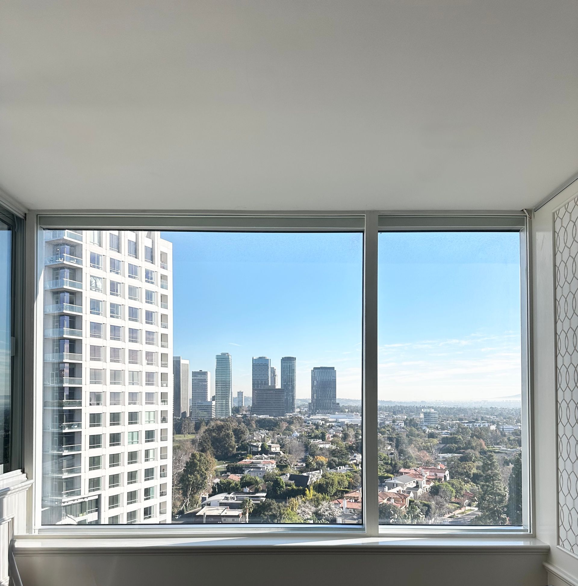 View from a high window of a city skyline on a sunny day.