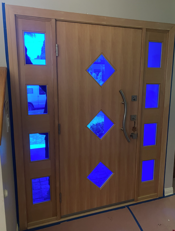 Wooden front door with blue glass inserts.