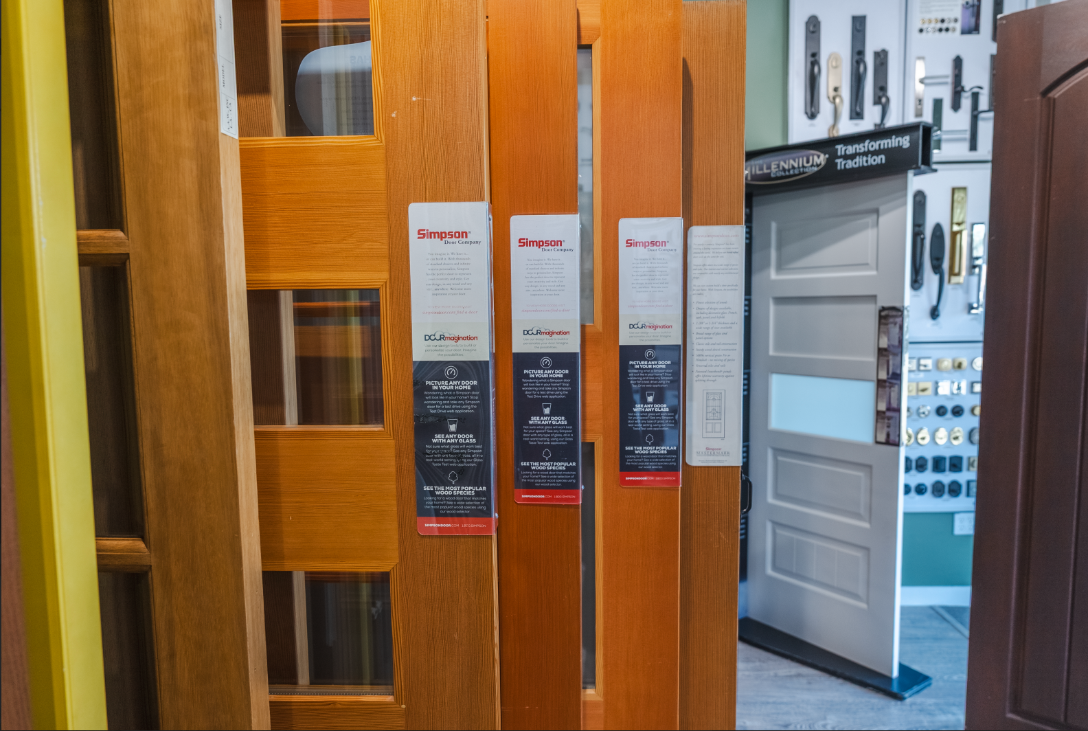 Wooden doors on display at a showroom, with informational tags attached.