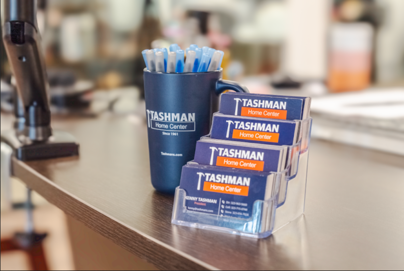 Business cards in a holder and pens in a cup on a counter at Tashman Home Center.