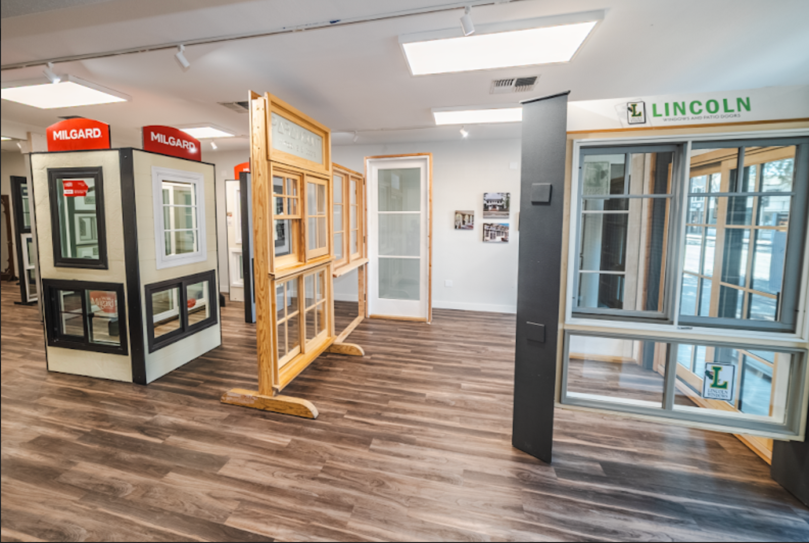 Interior of a showroom displaying different window styles on display stands.