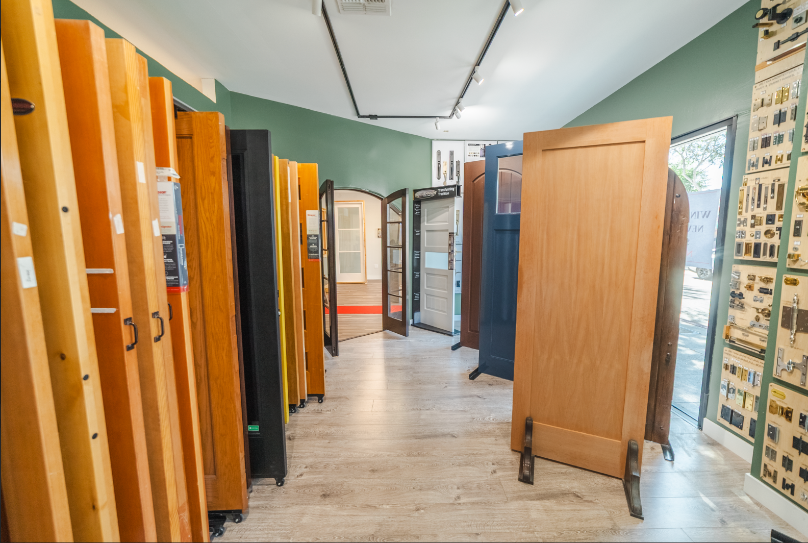 Interior of a door showroom with various wooden doors displayed for sale.