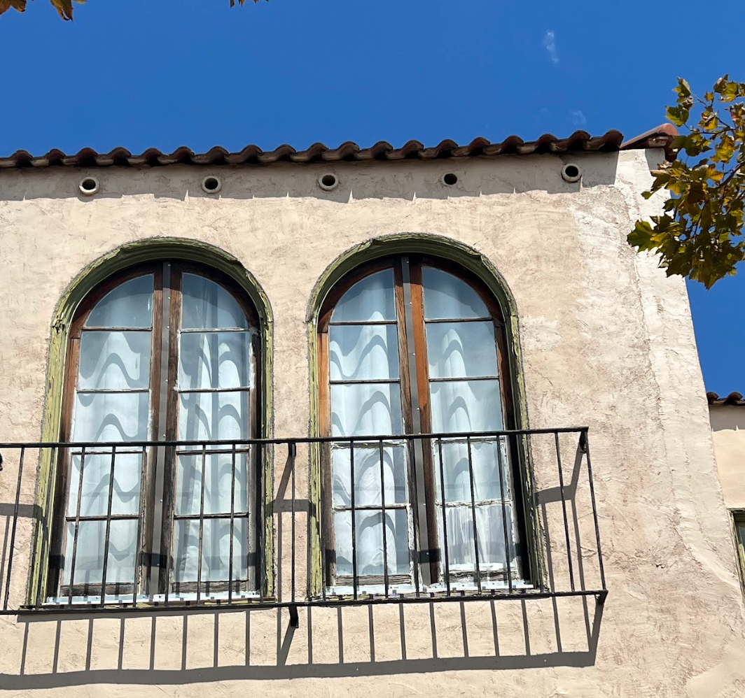 Exterior View of restored arched wood window with original trim preserved