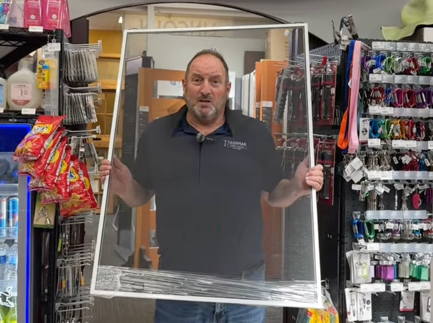 Kenny Tashman with his head through a screen