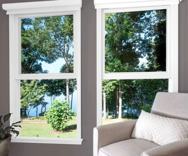 Luxurious villa with a pool, wooden deck, and lounge chairs. Palm trees and greenery surround the modern home.