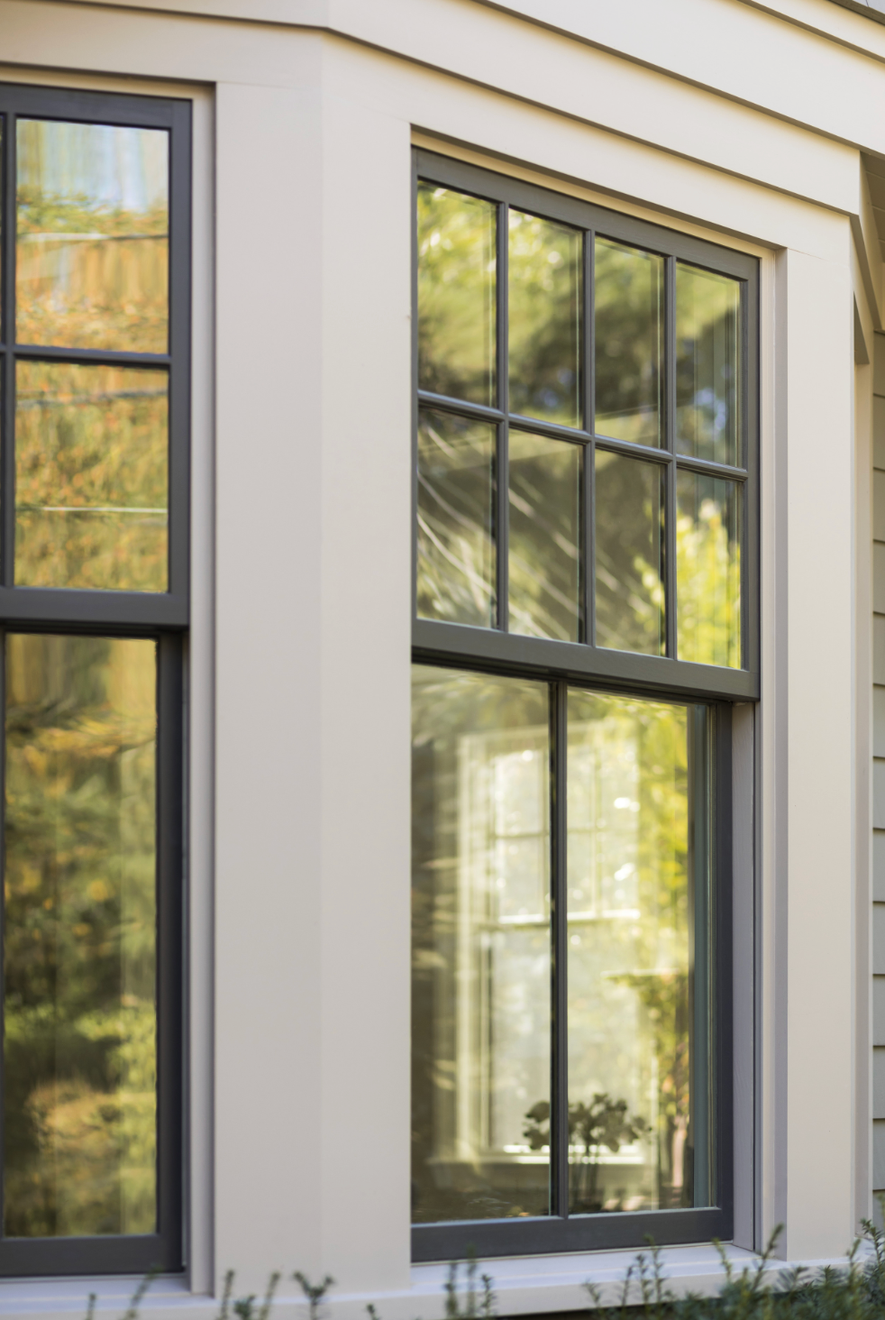Open arched windows with white frames, overlooking greenery and a balcony.