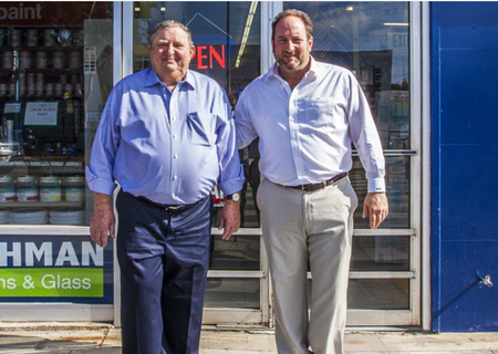 Two men standing outside a store with an 
