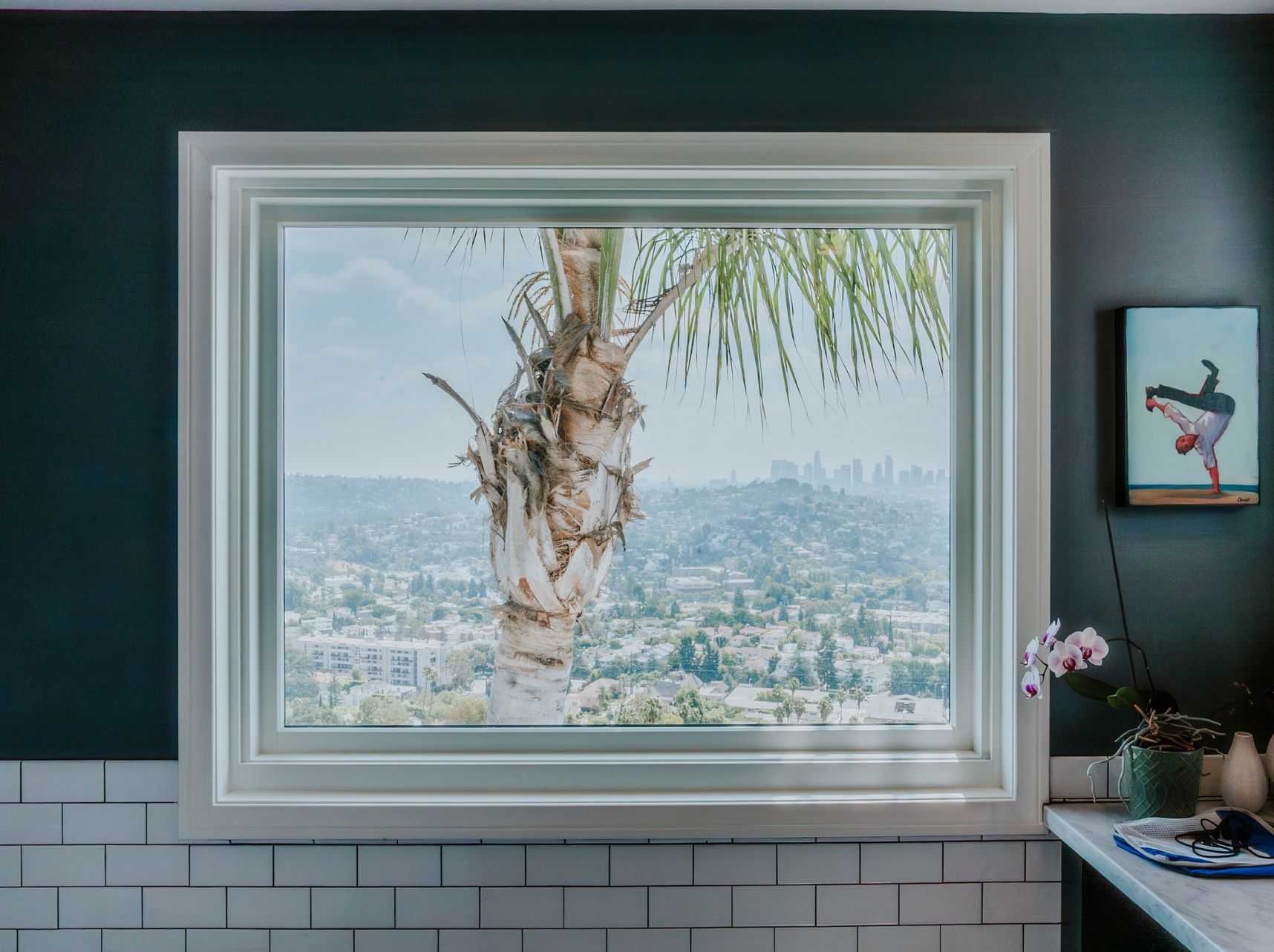 Close-up of a gray mesh material, with a curved edge and small, evenly spaced holes.