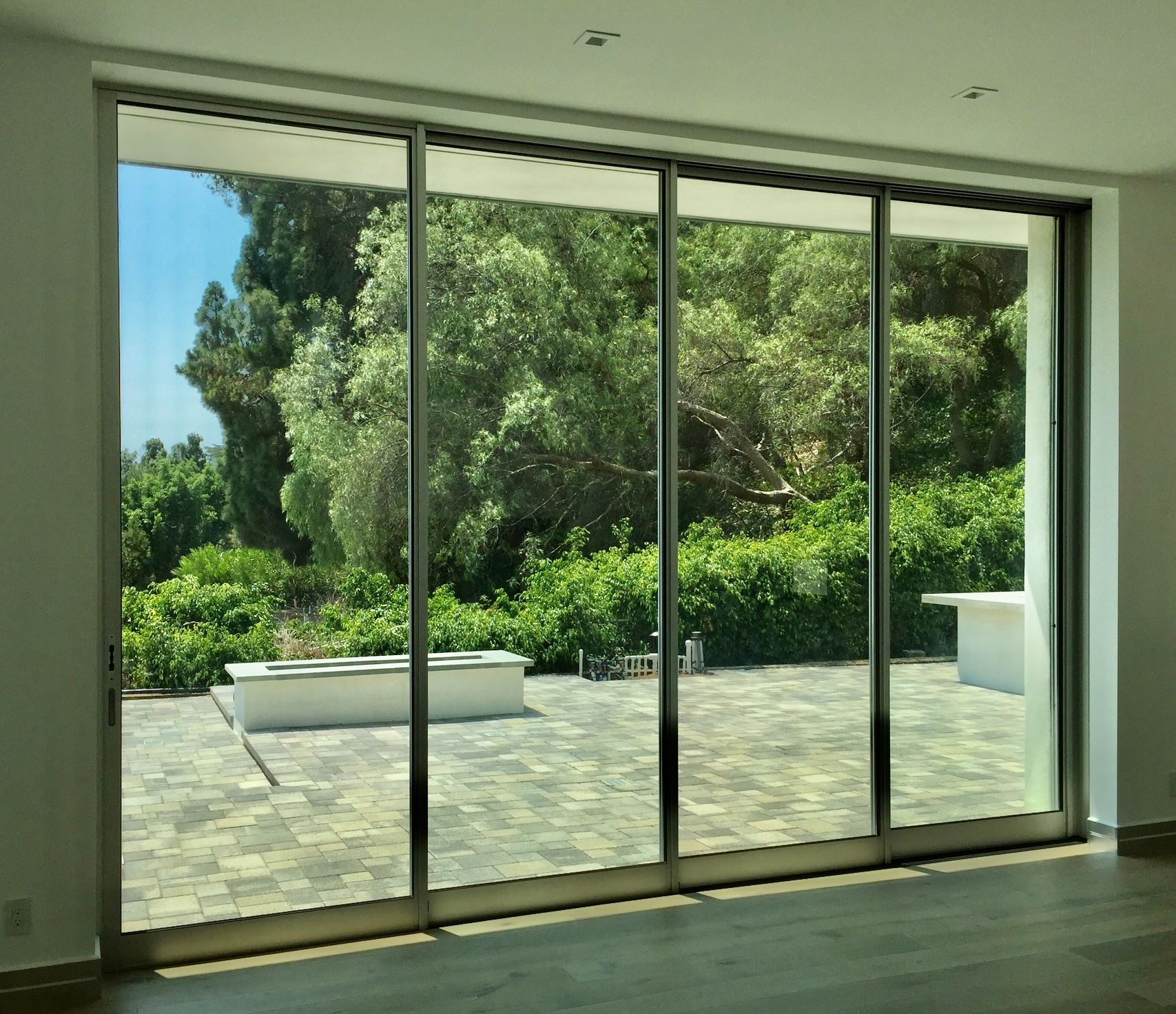 Large sliding glass doors open to a lush backyard patio.