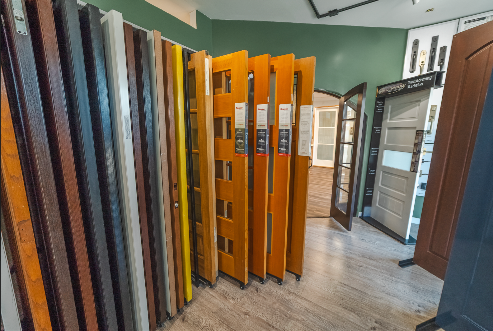 A showroom with various doors of different colors and styles on display.