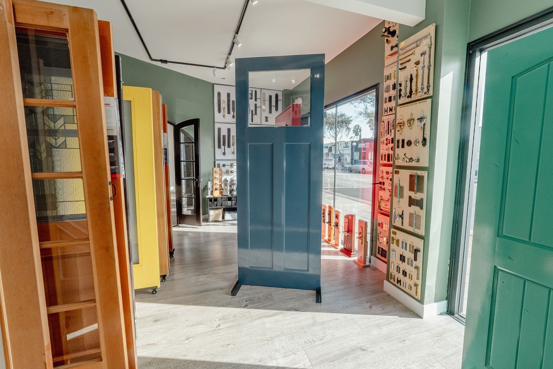 Sign in a window for Tashman Windows & Doors announcing a newly expanded showroom, now open.