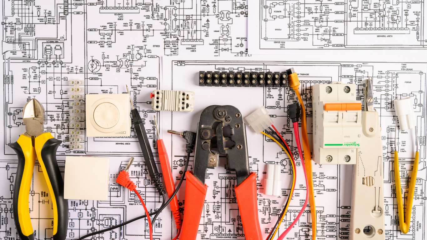 Electrical tools and components on a circuit diagram background.