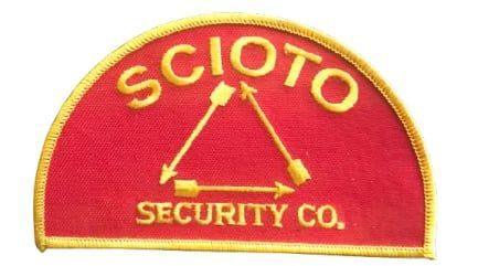 Red patch with "SCIOTO" above a triangle of arrows, and "SECURITY CO." below, all in gold.