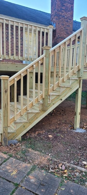 Wooden deck with stairs leading down to ground level.