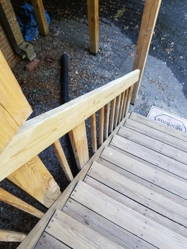Wooden outdoor staircase with handrail.