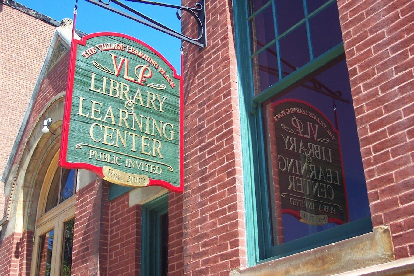 A brick building with a sign that says vlp library learning center