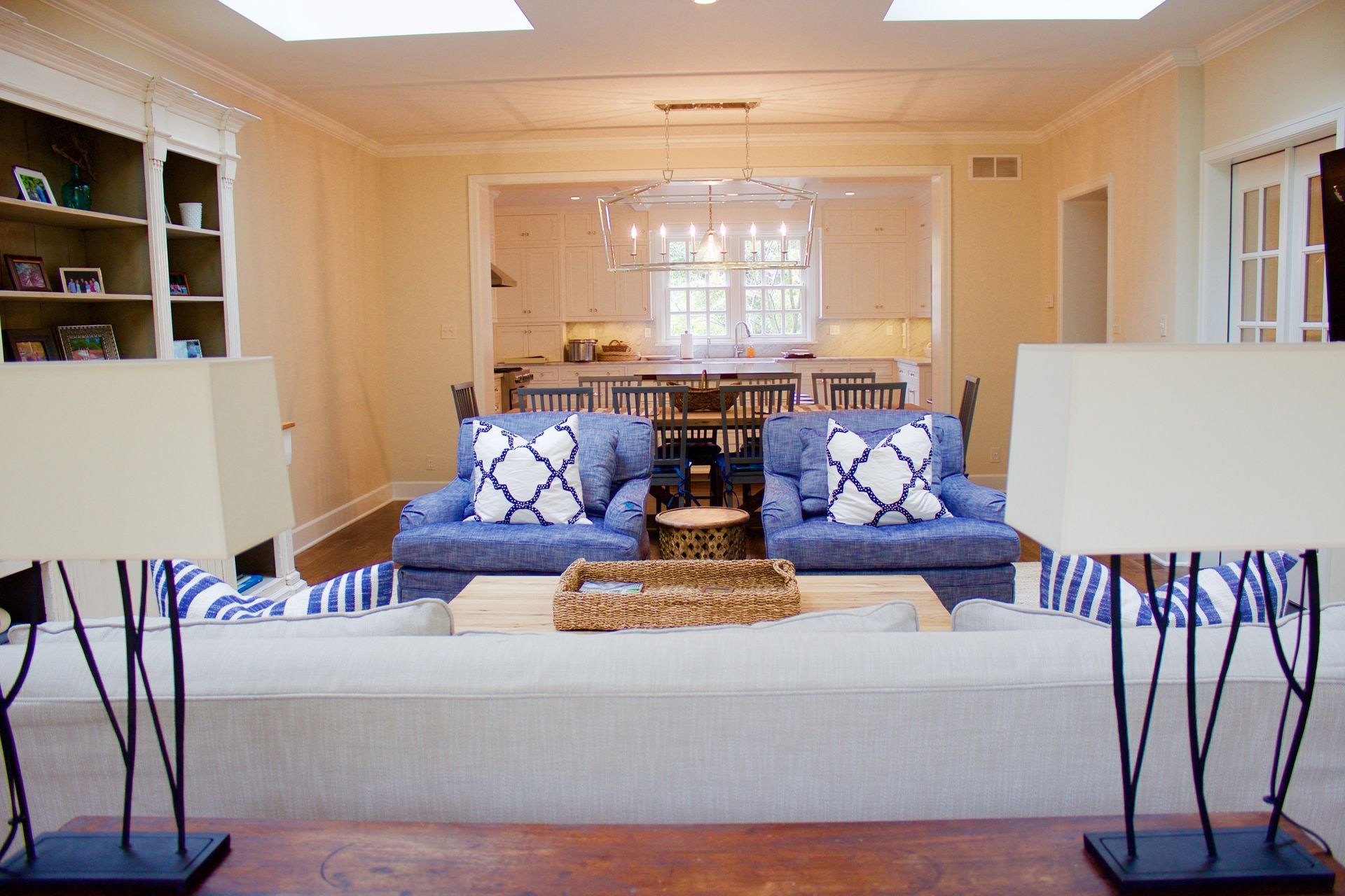 Cozy living room with a gray sofa, blue patterned pillows, and two black side tables with lamps