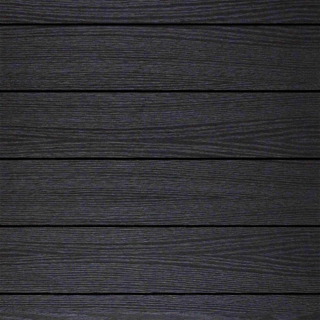 A close up of a black wooden surface with a grainy texture.