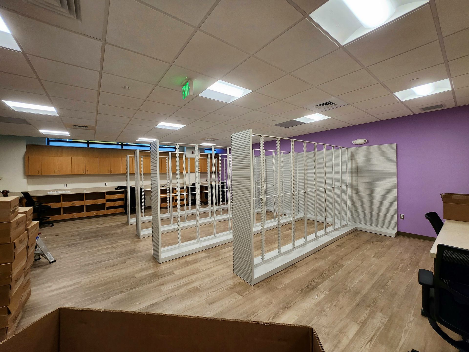 A room with a purple wall and a green exit sign — Aberdeen, MD — TLC Handyman Services LLC