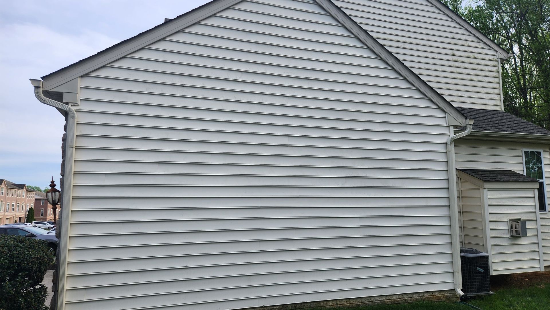 A white house with a gutter on the side of it — Aberdeen, MD — TLC Handyman Services LLC