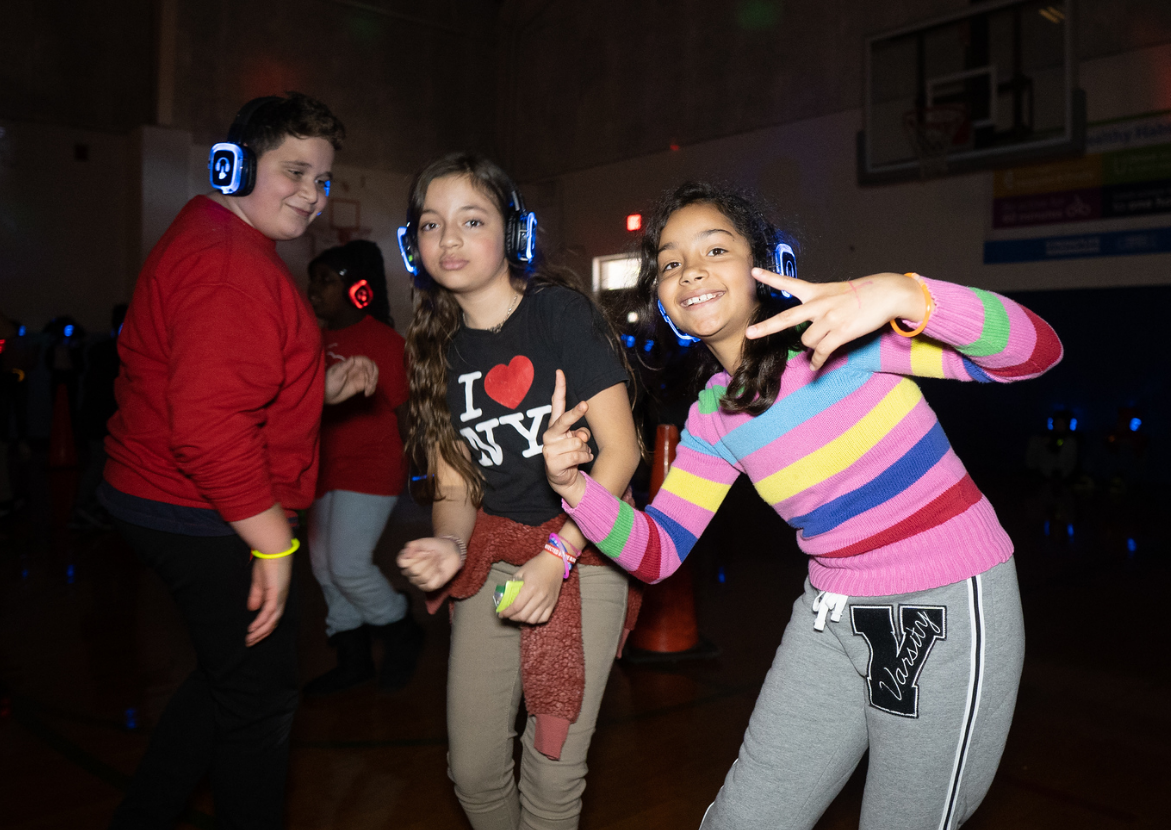 A dj is playing music in front of a crowd of people at a party.