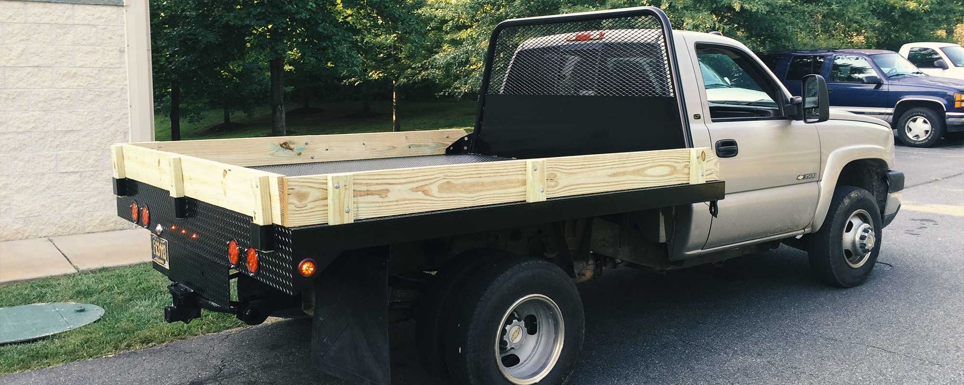 pickup truck modified with fabricated black metal back/bed
