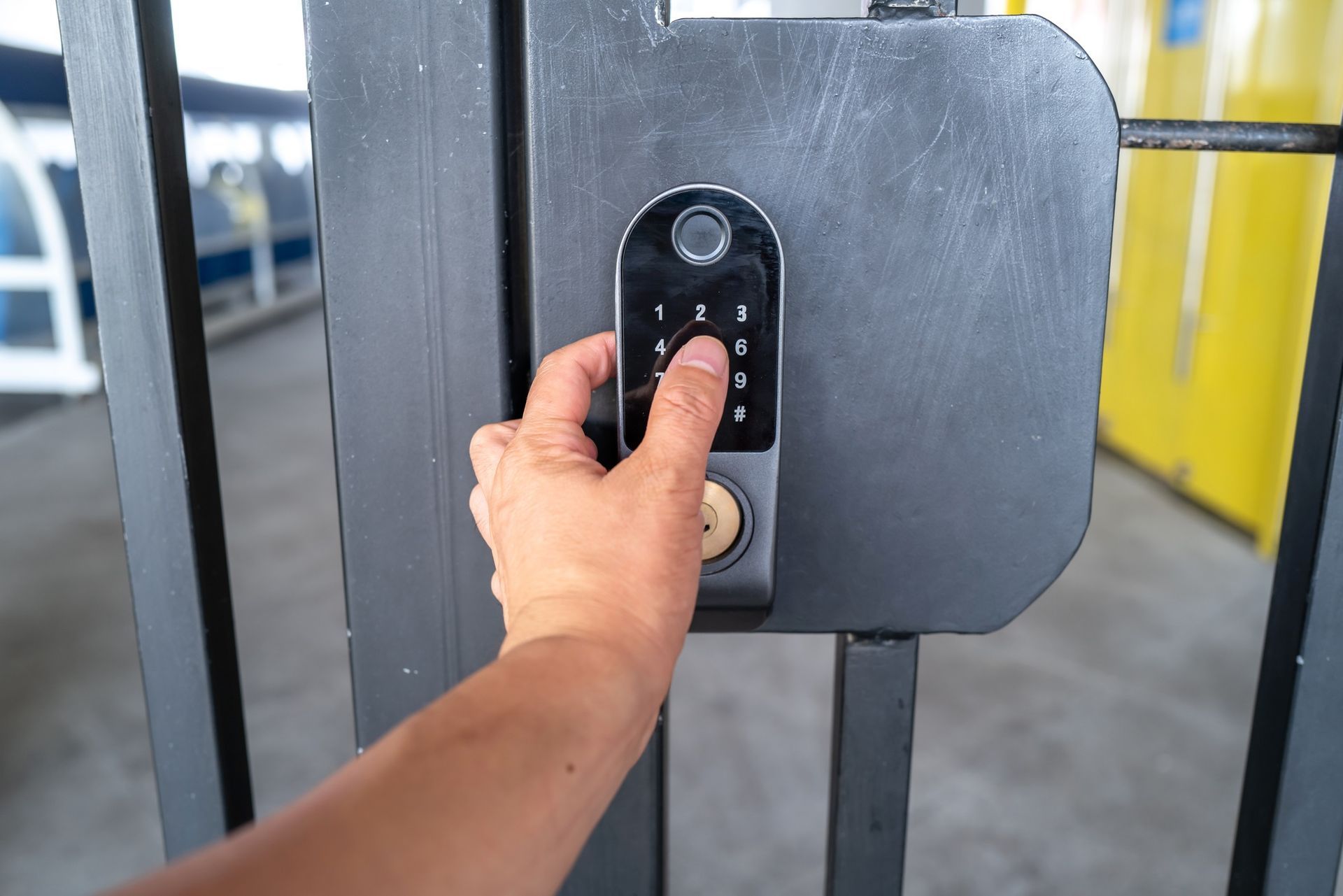 A person is using a keypad to lock a gate.