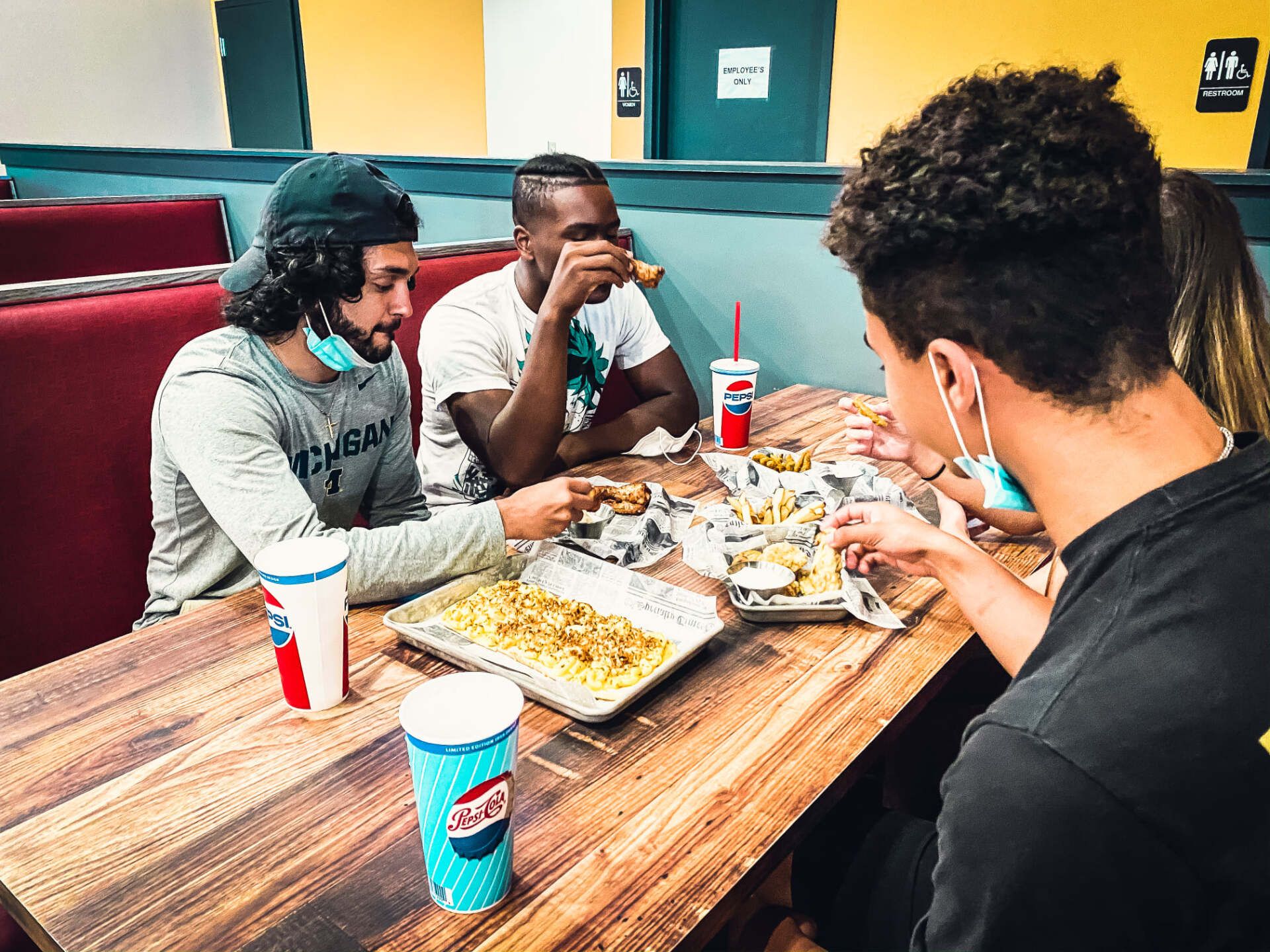 Friends eating fries - Canton, MI - The Tailgate Garage