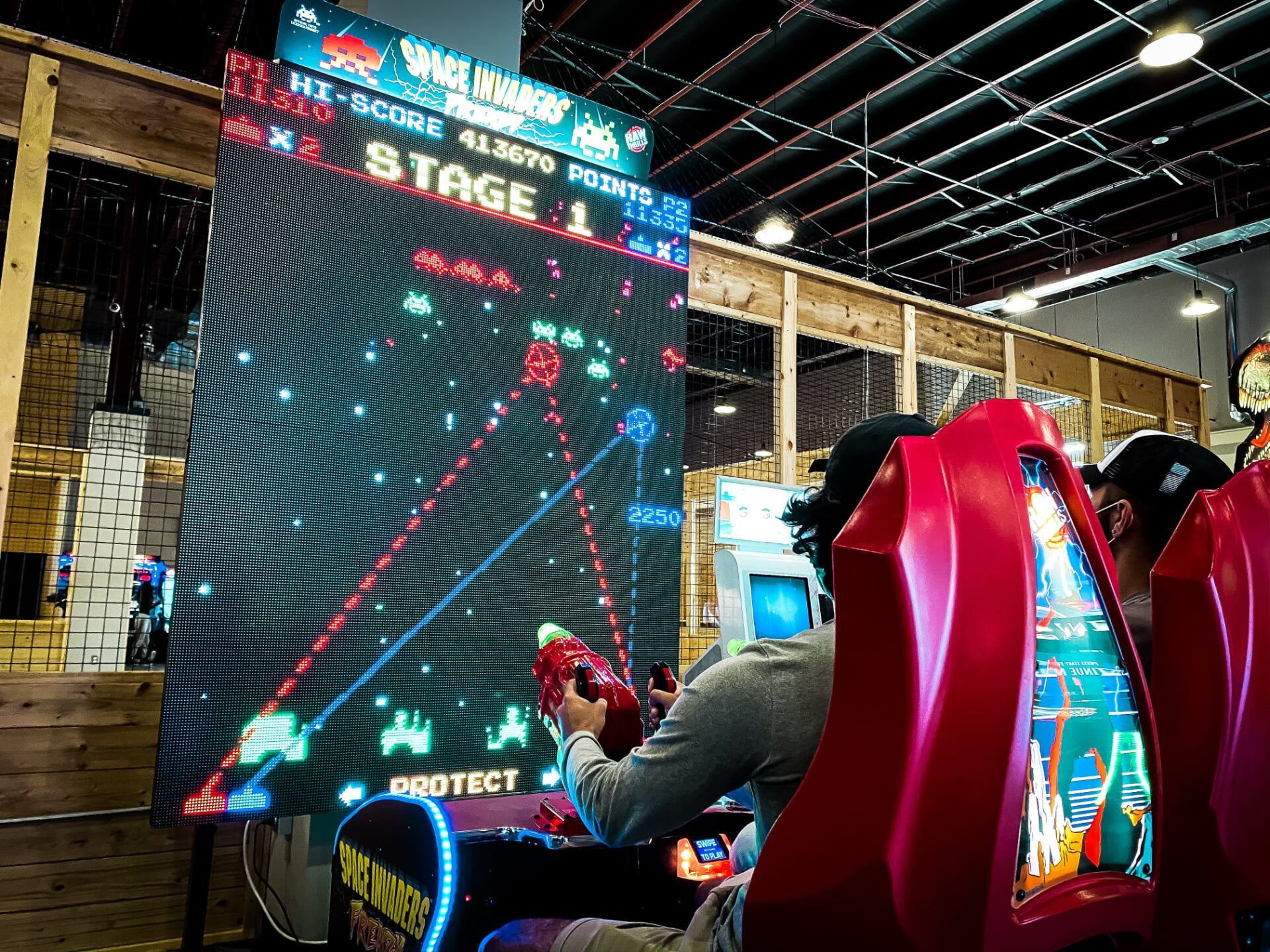 Man playing arcade games - Canton, MI - The Tailgate Garage