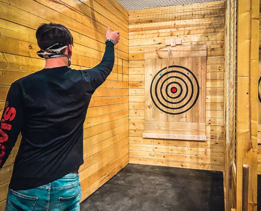 Player throwing ax - Canton, MI - The Tailgate Garage