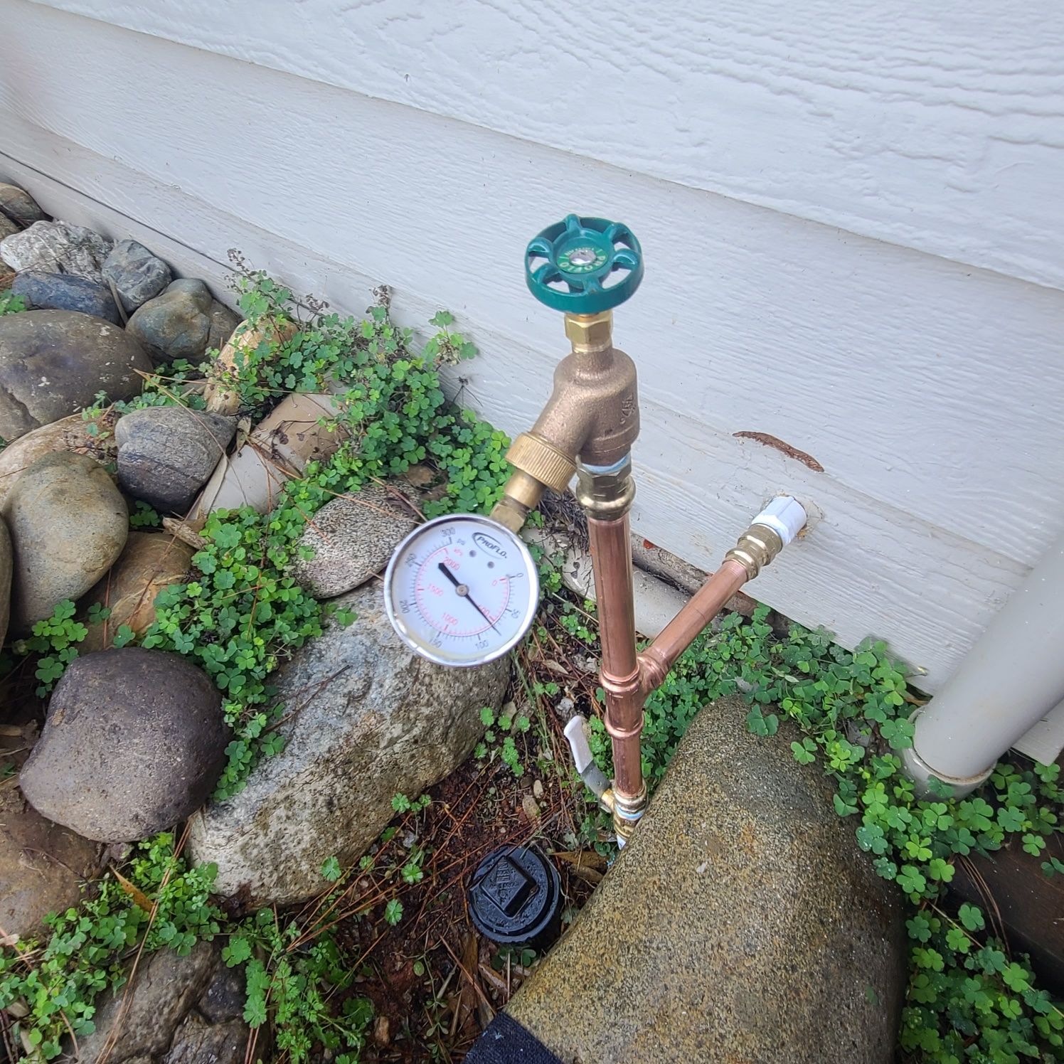 A white truck is parked in a parking lot next to a building.