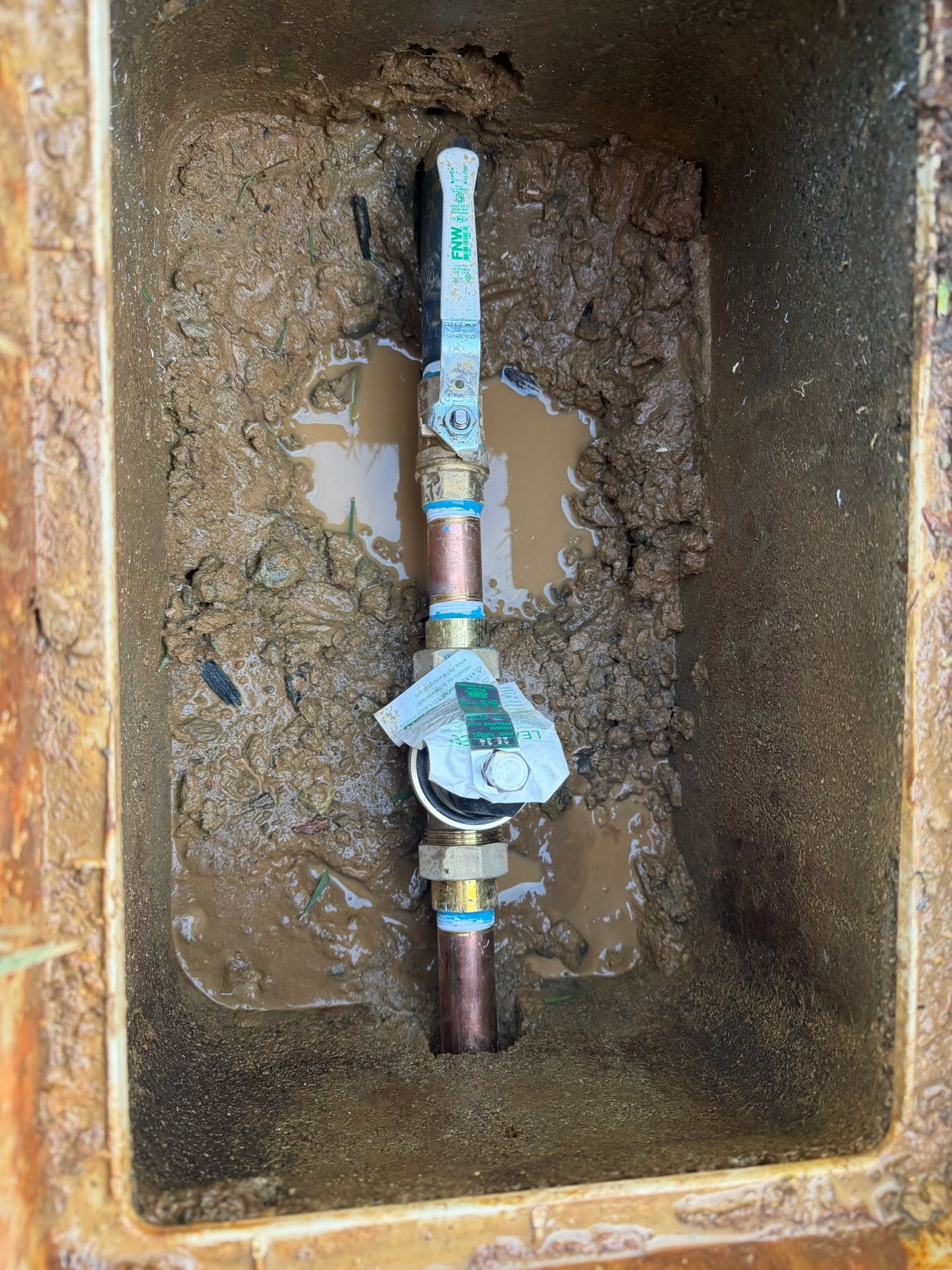 Plumbing pipes in attic. Copper and white pipes attached to wooden beams and insulation.