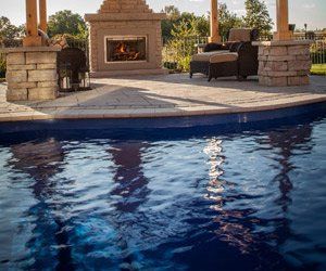 swimming pool near outdoor fireplace