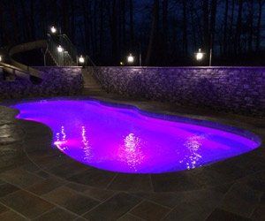 swimming pool with purple lighting at night