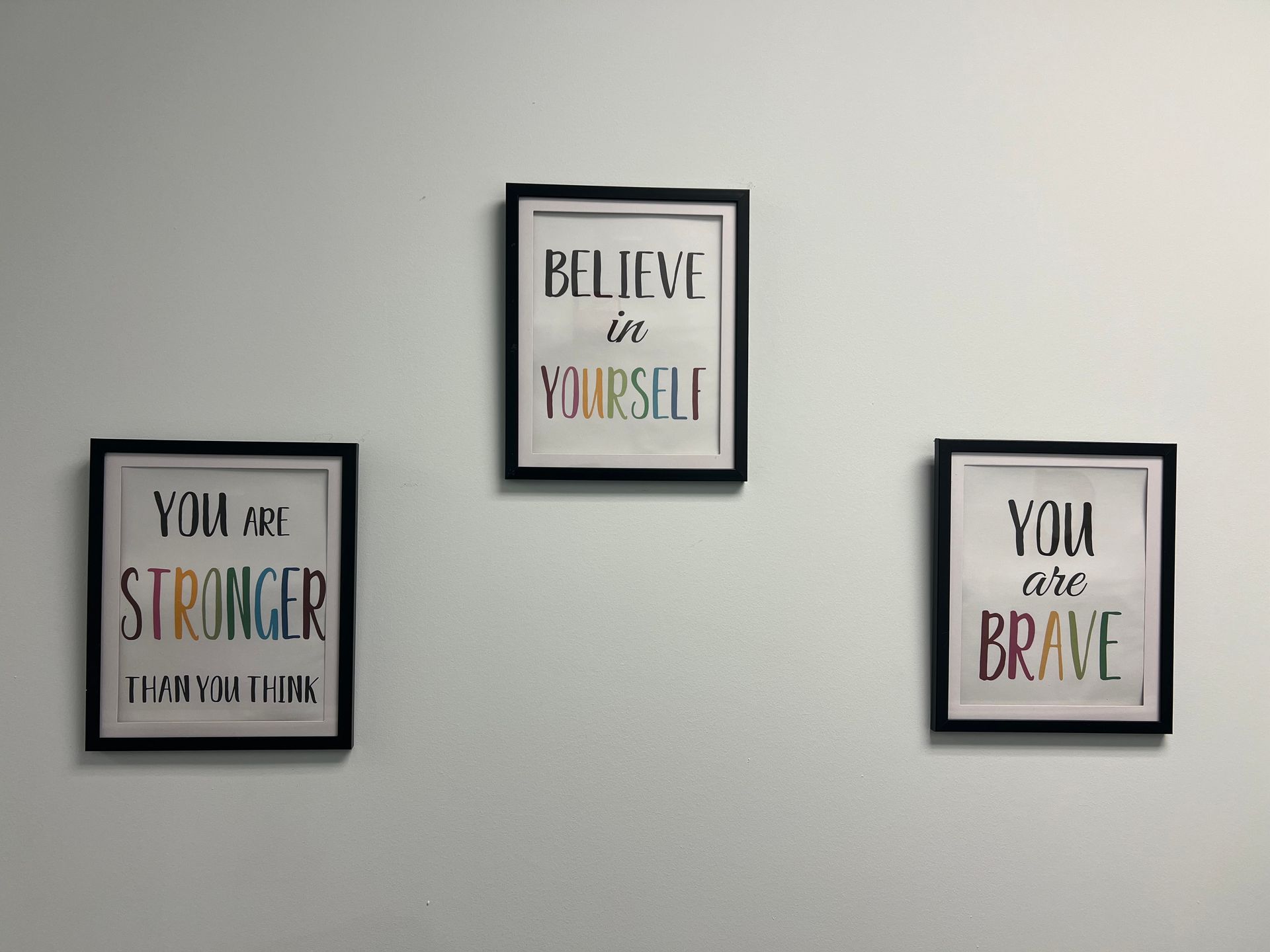 Three Framed Posters on a Wall